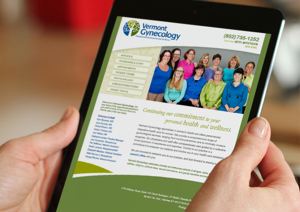 Hands holding iPad displaying Vermont gynecology website