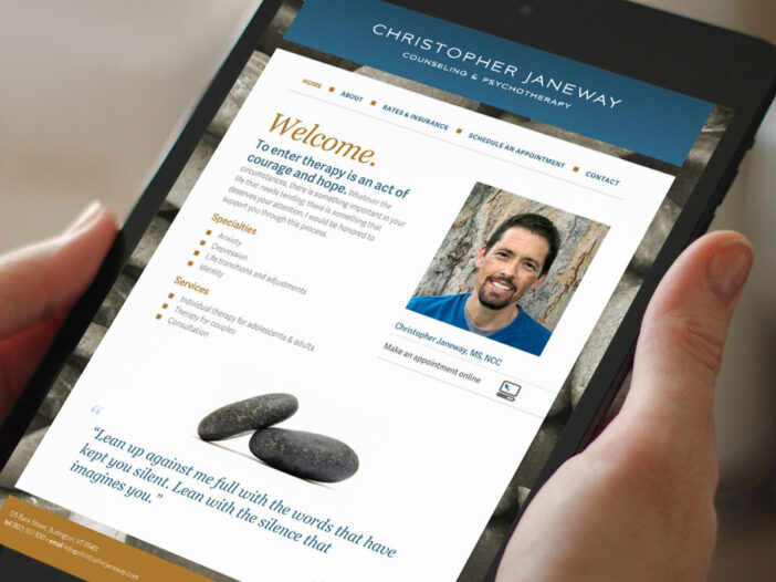 Hands holding mobile device displaying Christopher Janeway website