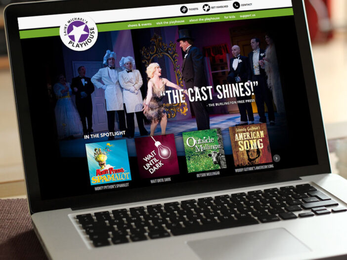 Laptop displaying Saint Michael's Playhouse web site