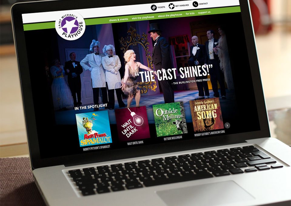 Laptop displaying Saint Michael's Playhouse web site