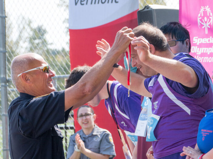 Two people cheering together at Special Olympics Games