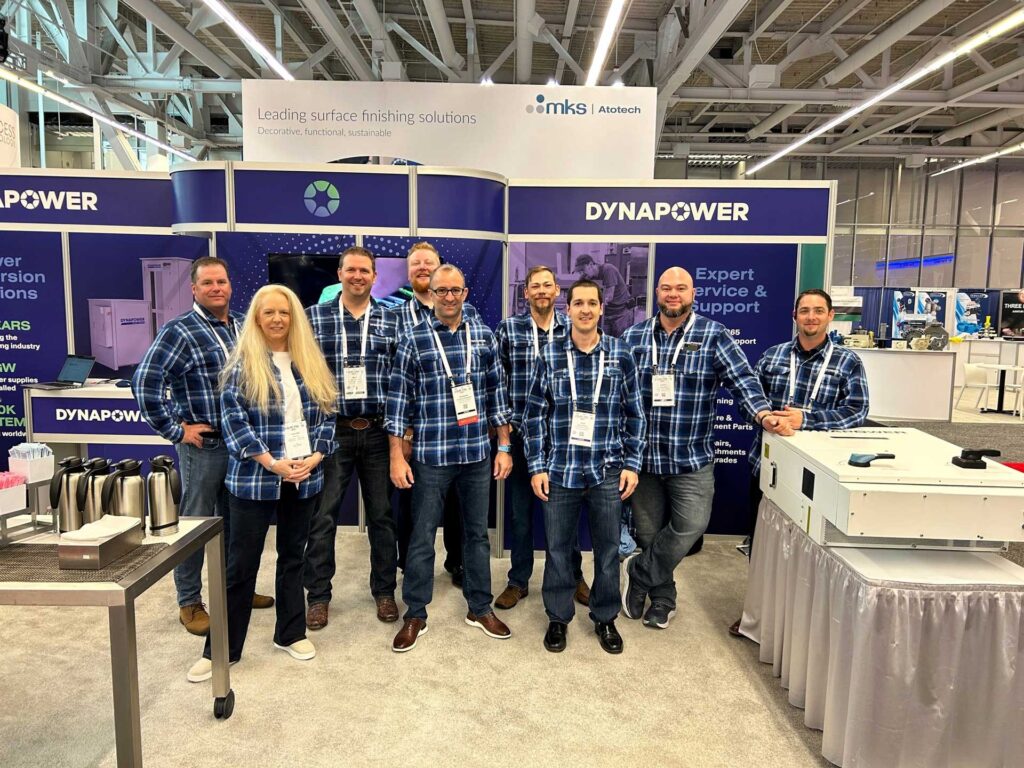Dynapower staff a SUR/FIN trade show wearing matching blue flannel shirts