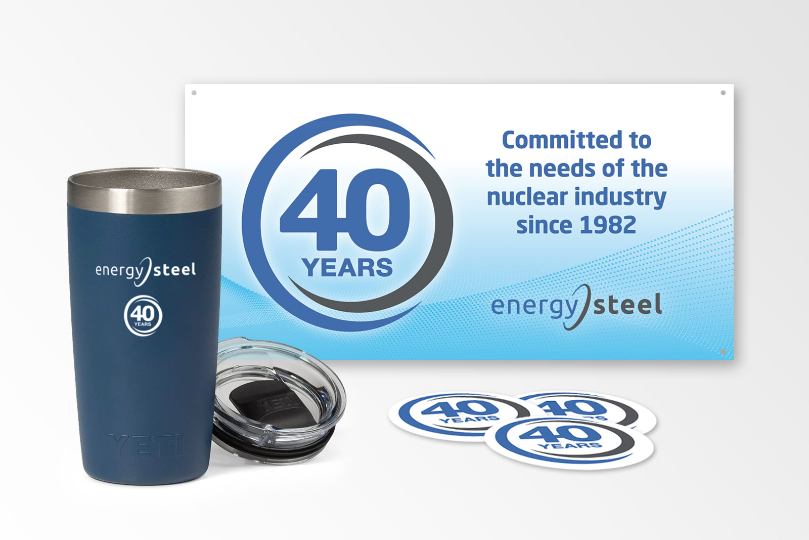 a coffee mug, stickers, and a logo for energy steel's anniversary campaign