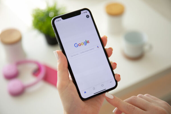 hand holding a phone with Google on the screen