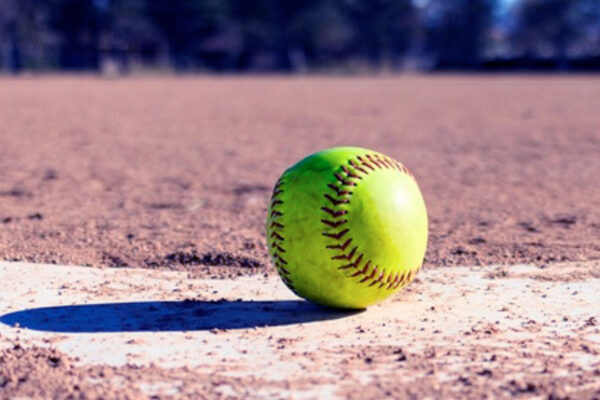 Closeup of softball on a baseball home plate