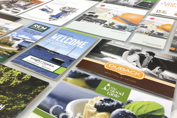 Assortment of print advertisement covers laid out