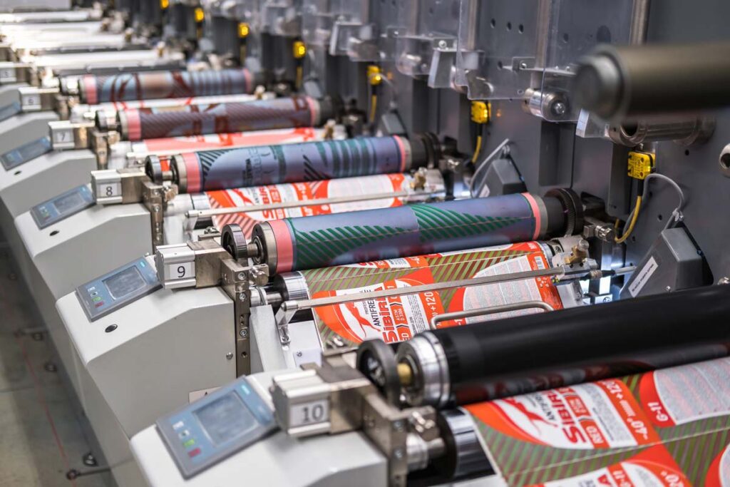 rows of brochures in large offset printing press