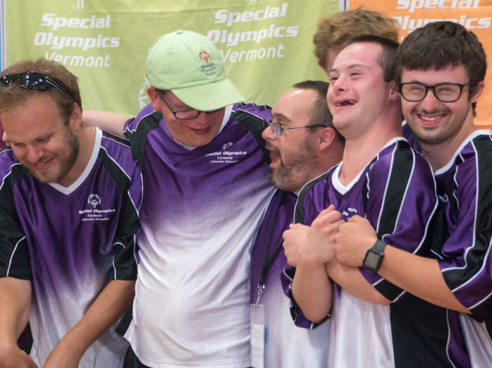 A group of athletes smiling in a group
