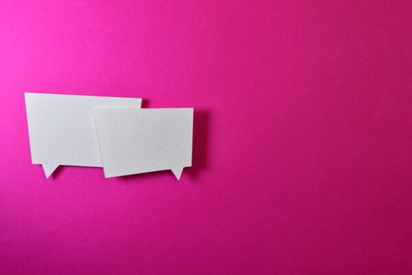 pink wall with two sticky notes