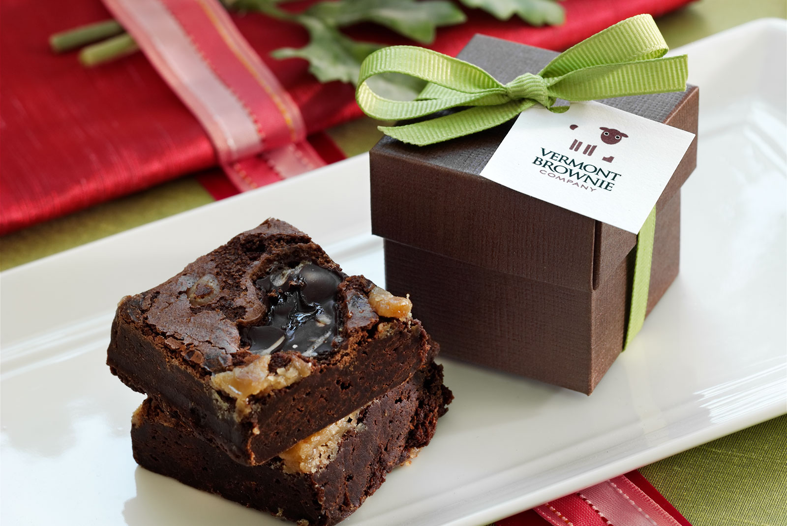 Two brownies next to a box with a bow
