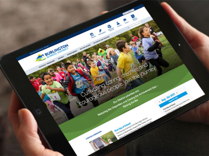 Hands holding iPad displaying Burlington School District website