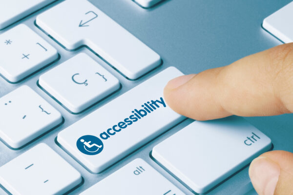 person's finger clicking button that reads "accessibility" with wheelchair symbol