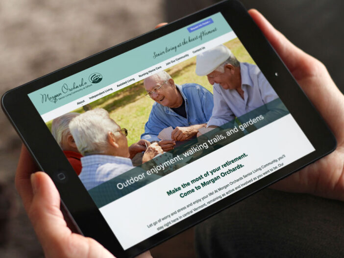 Hands holding iPad displaying Morgan Orchards website
