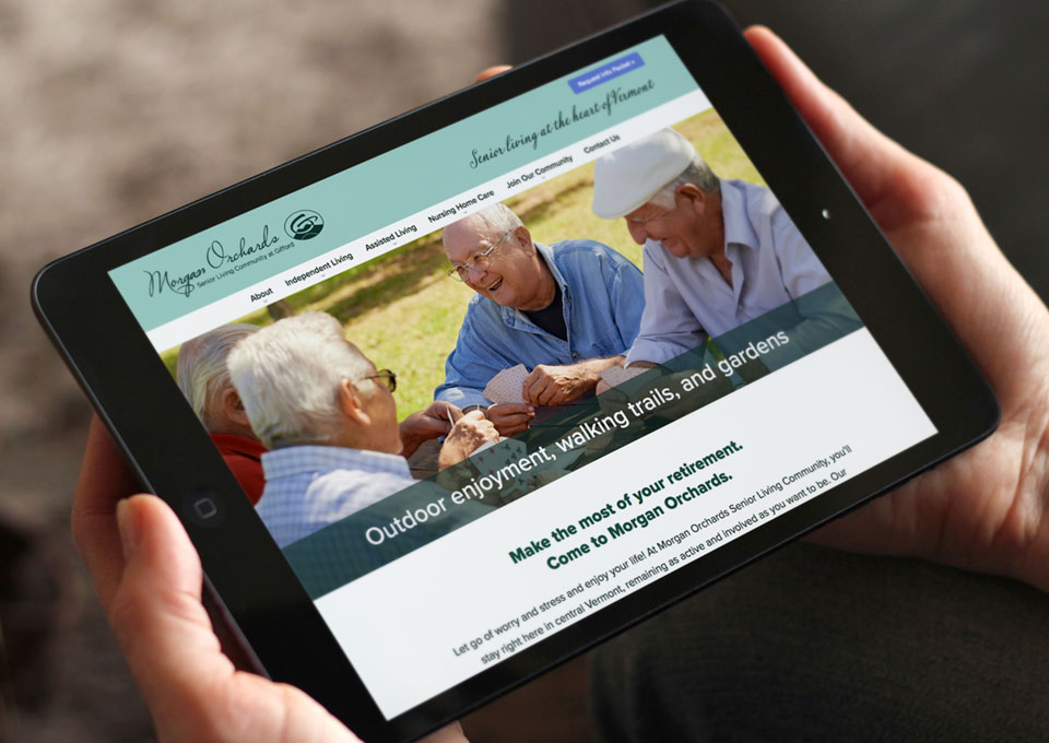 Hands holding iPad displaying Morgan Orchards website